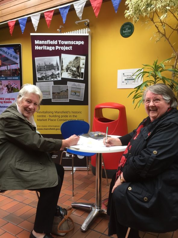 Two ladies at a table writing their Mansfield memories on postcards | Pete Brown